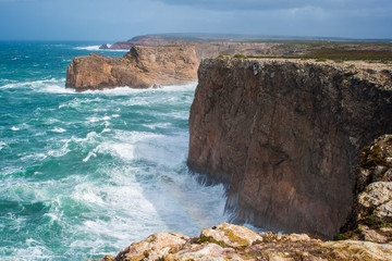 Fototapeta na wymiar Cliffs at Cape Saint. Vicent in Algarve region on a windy day. Portugal. 