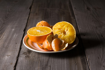 various types of citrus fruit on a dark wooden background
