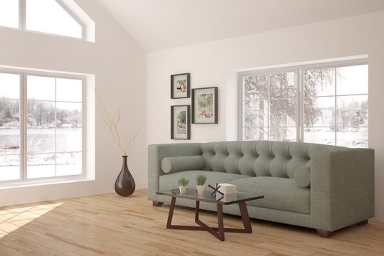 White interior design with sofa and winter landscape in window