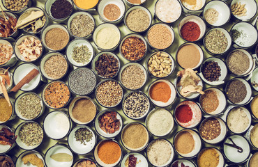 background texture of all sorts of spices  in small bowls