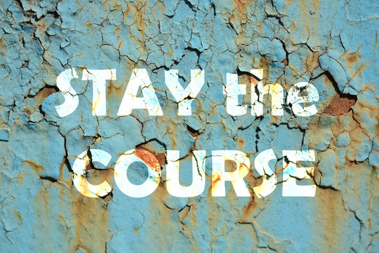 stay the course words print on the grunge metallic wall