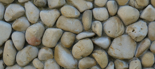 wall of round stones as a background