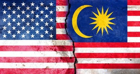 A large crack in the wall. USA flag. Flag of Malaysia