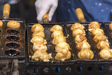 Traditional and very famous Japanese dish - Takoyaki, street food in Osaka, Japan