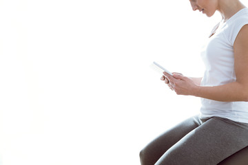 Beautiful young woman using her digital tablet at home.