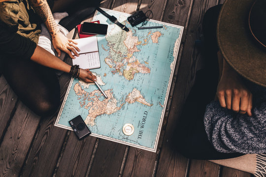 Couple planning vacation using the world map.