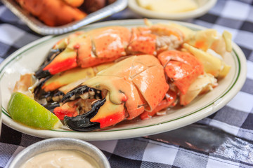 Stone crab claws with lemon butter and mustard on a plate as photographed in south beach miami florida