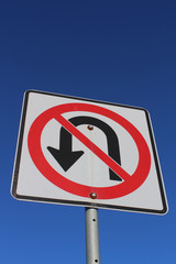 No U-Turn Sign Against Blue Sky