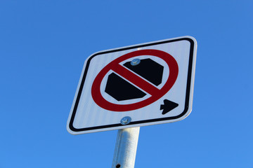 No Stopping Right of Sign Against Blue Sky