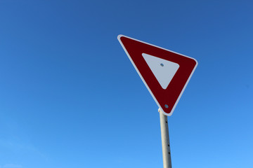 Yield Sign Against Blue Sky
