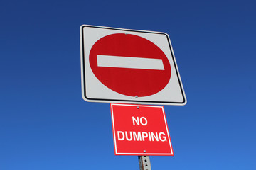 No Entry or Dumping Sign Against Blue Sky