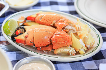 Stone crab claws with lemon butter and mustard on a plate as photographed in south beach miami florida © navintar