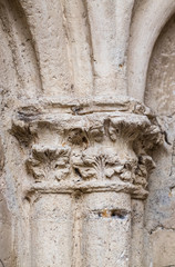 ancient limestone pillar with sculpture damaged by pollution for craftsmanship