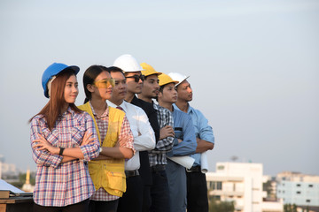  Group of engineers and architects standing and looking at site