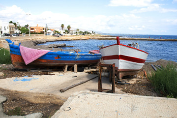 Colorful fishing boats by the coast of the town of Noto, Sicily, Italy