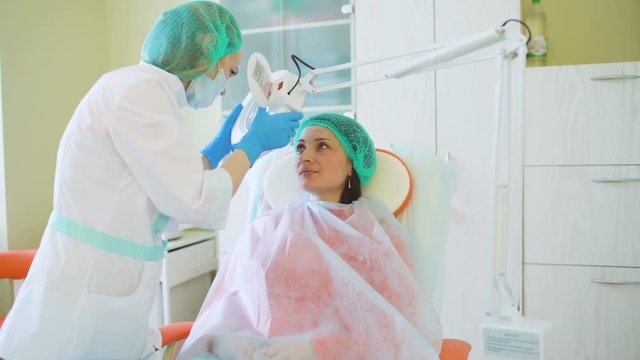 Cosmetology doctor female reviewing of her pation in medical clinic