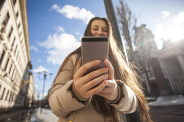 Gorgeous beautiful brunette young woman taking a selfie with smart-phone.
