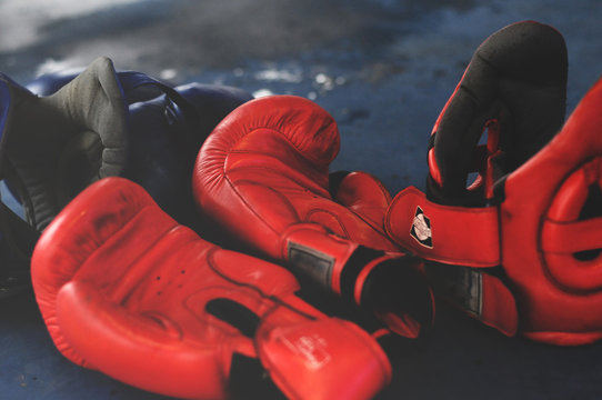 Red Boxing Gloves and Headgear on Boxing Ring.