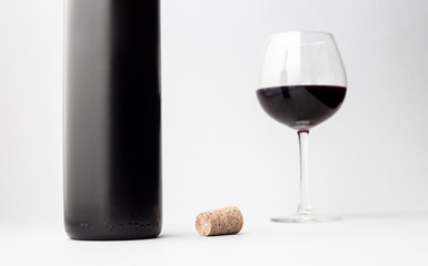 Wine bottle and glass on a gray background