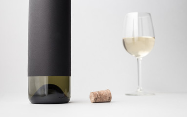 Wine bottle and glass on a gray background