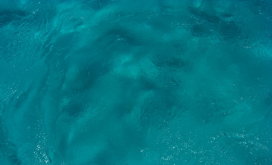 The texture of the seafloor through the clear water