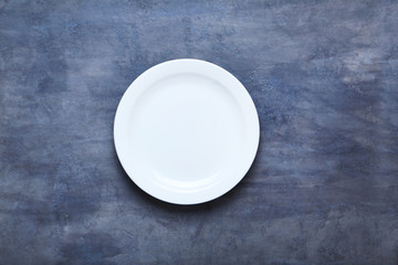 Empty plate on grey wooden table