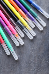Fototapeta premium Felt-tip pens on a grey wooden table