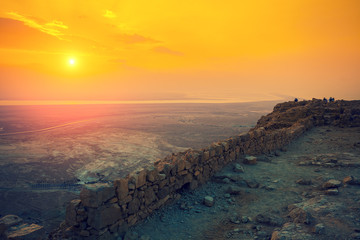 Beautiful sunrise over Masada fortress. Ruins of King Herod's palace in Judaean Desert.