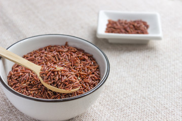Obraz na płótnie Canvas Raw red wild rice in ceramic bowl. Cereal for rice cereal