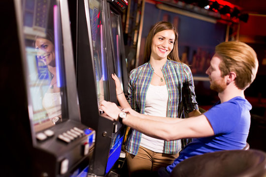 Young couple on slot machine in the casino