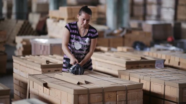 A woman working at the plant packs polyethylene refractory bricks.