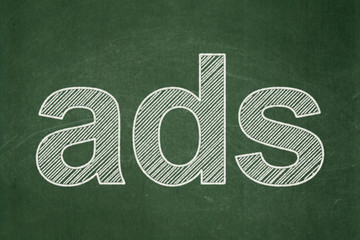 Marketing concept: Ads on chalkboard background