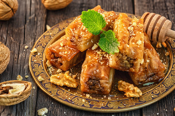 Traditional arabic dessert Baklava with honey and walnuts.