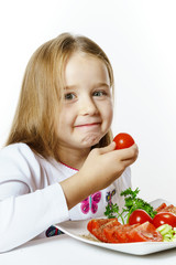 Cute little girl with plate of fresh vegetables