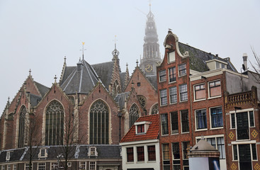 Fototapeta na wymiar Old Church and historical houses in Amsterdam