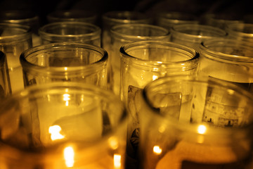 Glass Jars Candles Glowing in the Darkness