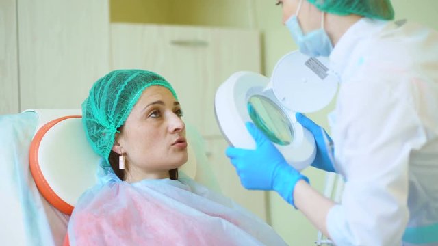 Cosmetology doctor female reviewing of her pation in medical clinic