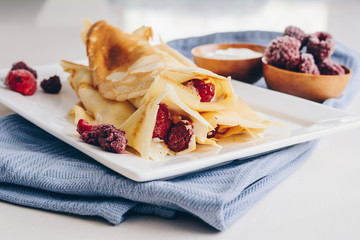 Pancakes with raspberries and sweet cream