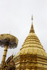 Golden pagoda in the temple on background sky.