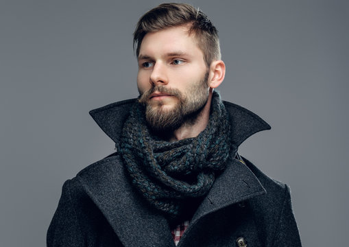 A man dressed in a jacket and scarf.