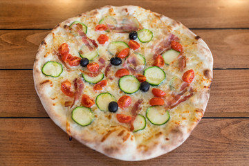 Pizza Italiana on wooden table.