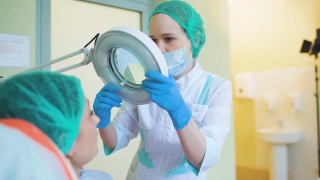 Cosmetology doctor female reviewing of her pation in medical clinic