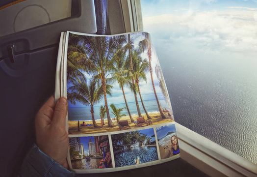 Woman is sitting   by window on a plane with magazine in hands. Concept art