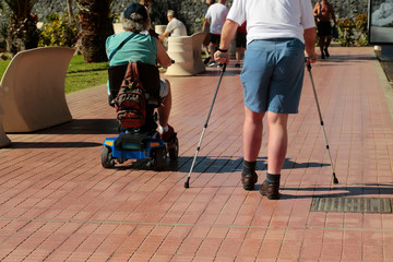 Disabled men walk on promenade