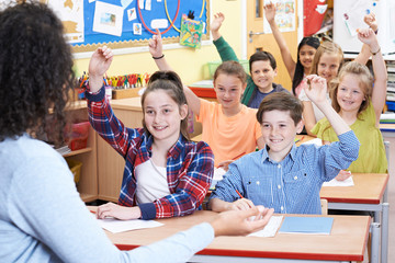Elementary Pupils Answering Question In Class