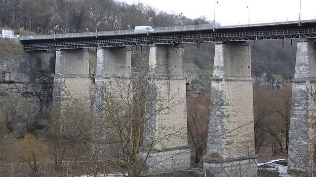 Novoplanovskiy bridge in Kamianets-Podilskyi city, located in historic region of Podolia in western Ukraine. Cars on the stone bridge above Smotrych river in Kamianets-Podilskyi city, length 136 m