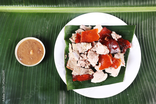 chopped-parts-of-the-delicacy-lechon-or-suckling-pig-on-a-banana-leaf