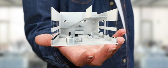 Businessman holding white 3D rendering apartment in his hand