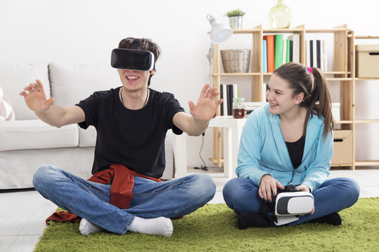 Boy and a Girl with VR glasses in living room