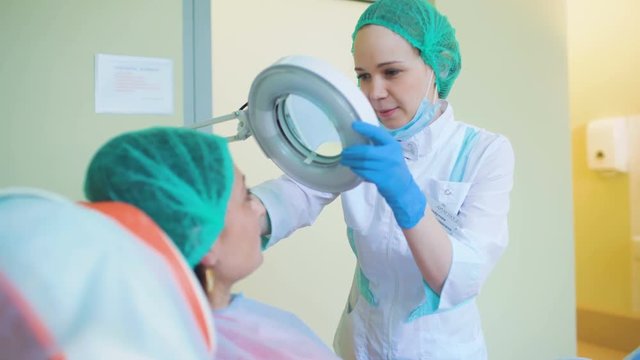 Cosmetology doctor female reviewing of her pation in medical clinic